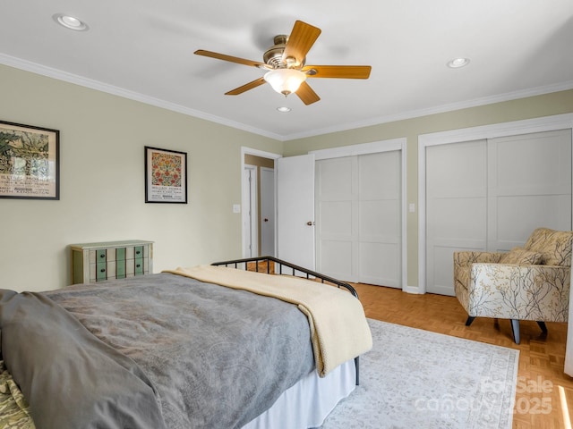 bedroom with crown molding, recessed lighting, and multiple closets