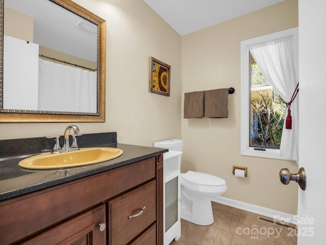 full bath with toilet, visible vents, baseboards, vanity, and tile patterned floors