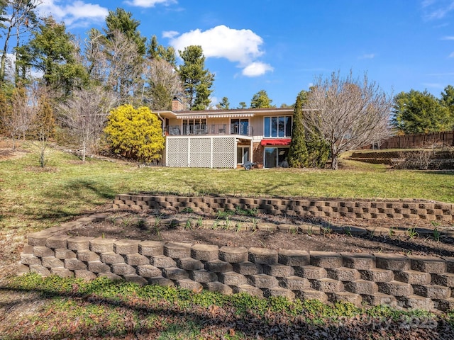 back of property featuring a lawn and a chimney