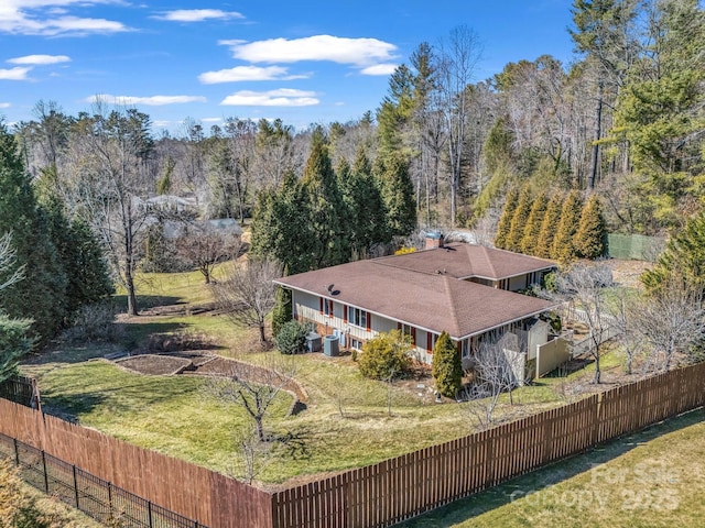 birds eye view of property with a view of trees