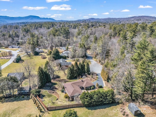 birds eye view of property with a forest view and a mountain view