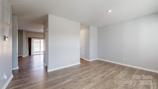 empty room with recessed lighting, baseboards, and wood finished floors