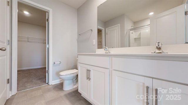 full bath featuring recessed lighting, a spacious closet, toilet, a stall shower, and vanity