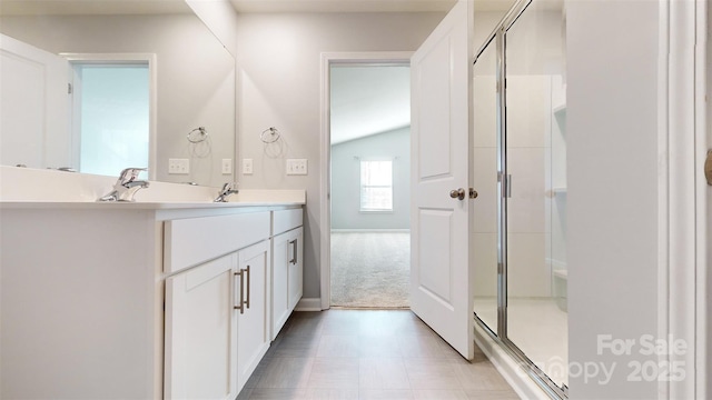 full bathroom featuring lofted ceiling, a stall shower, and vanity