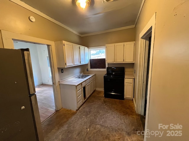 kitchen featuring freestanding refrigerator, black electric range, white cabinets, and a sink