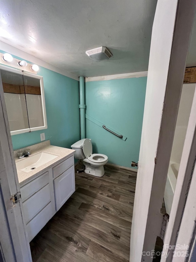 full bathroom featuring visible vents, a shower, toilet, wood finished floors, and vanity