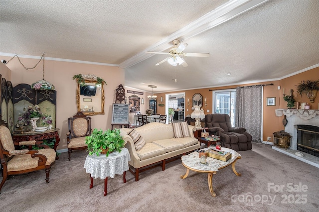 living room with a glass covered fireplace, ceiling fan, ornamental molding, a textured ceiling, and carpet flooring