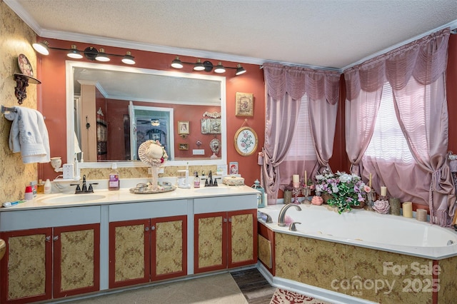 bathroom featuring double vanity, ornamental molding, a sink, a textured ceiling, and a bath