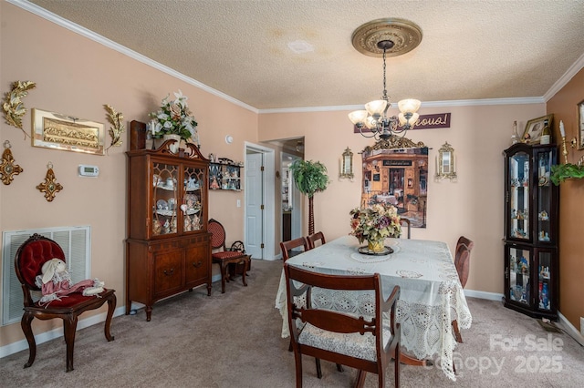 dining area with light carpet, baseboards, ornamental molding, a textured ceiling, and a chandelier