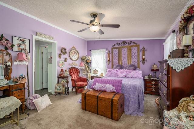 carpeted bedroom featuring a textured ceiling, ornamental molding, and a ceiling fan