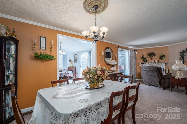 dining space featuring an inviting chandelier, a textured ceiling, crown molding, and carpet flooring