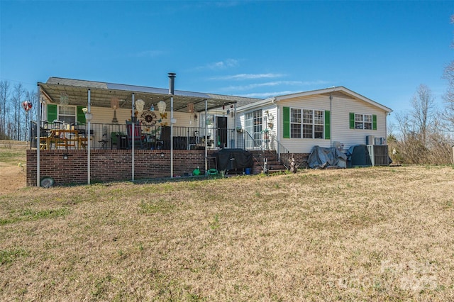 rear view of house featuring a yard