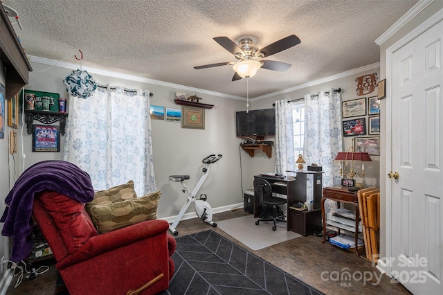 office featuring a textured ceiling, ornamental molding, a ceiling fan, and baseboards