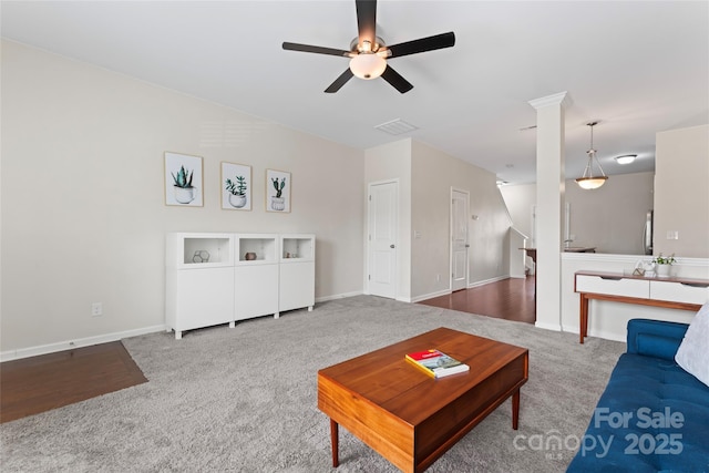 carpeted living area featuring visible vents, baseboards, and a ceiling fan