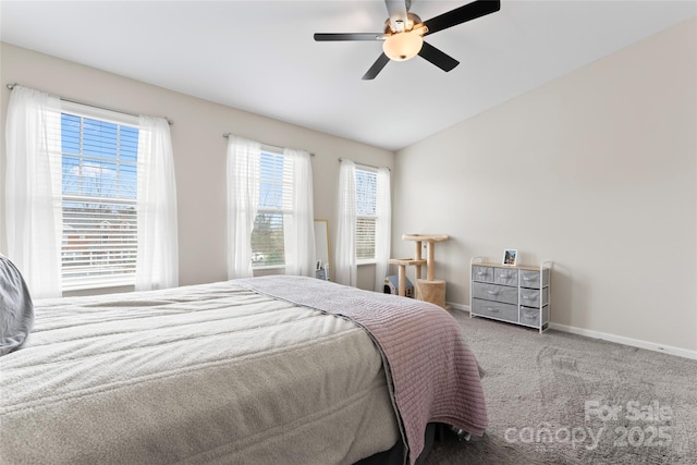 carpeted bedroom featuring lofted ceiling, baseboards, and ceiling fan