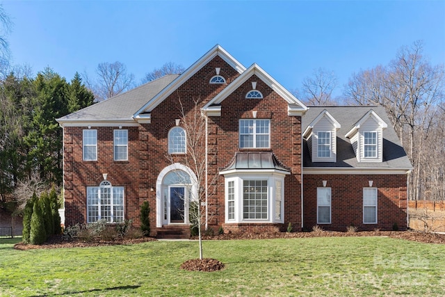 view of front of house with a front lawn and brick siding