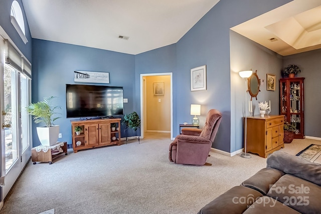 living room with light colored carpet, visible vents, and baseboards