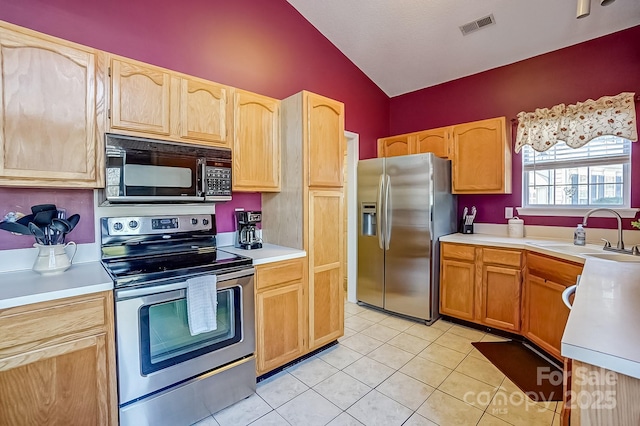 kitchen featuring light tile patterned floors, visible vents, stainless steel appliances, light countertops, and a sink