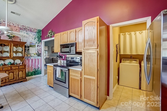 kitchen with visible vents, washer and clothes dryer, stainless steel electric range oven, light countertops, and black microwave