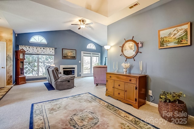 sitting room featuring visible vents, a ceiling fan, light carpet, a tile fireplace, and baseboards