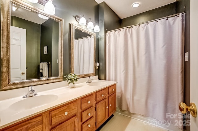 bathroom featuring double vanity, shower / bath combo, and a sink