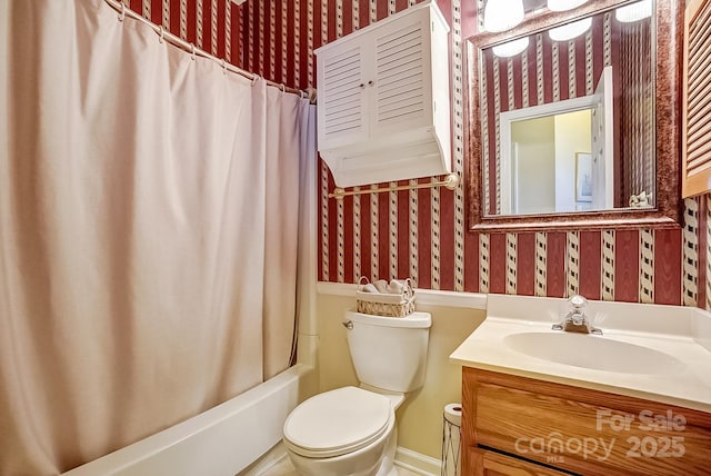 bathroom featuring shower / tub combo, vanity, toilet, and wallpapered walls