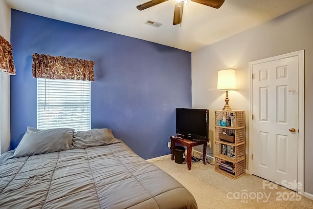 carpeted bedroom with visible vents and ceiling fan