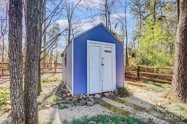 view of shed featuring fence