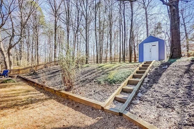 view of yard featuring a shed, fence, and an outdoor structure