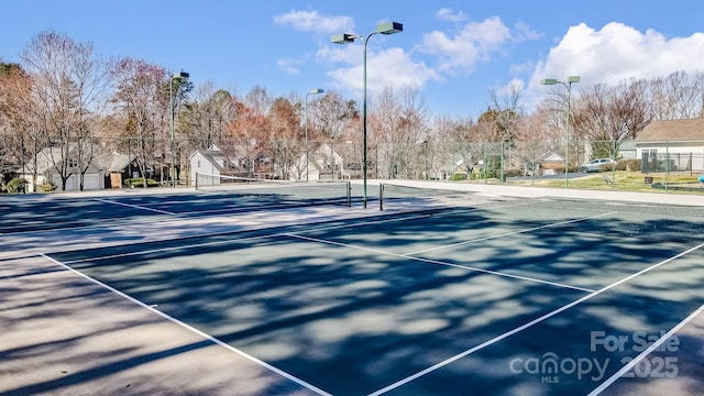 view of tennis court featuring fence