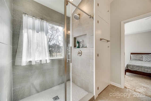 ensuite bathroom with ensuite bath, tiled shower, and tile patterned floors