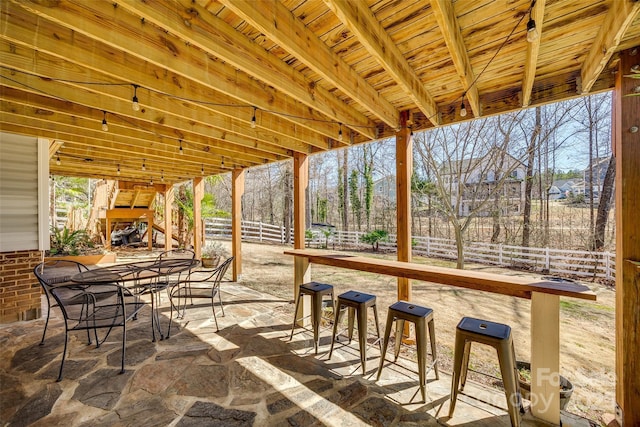 view of patio / terrace with outdoor dry bar and fence