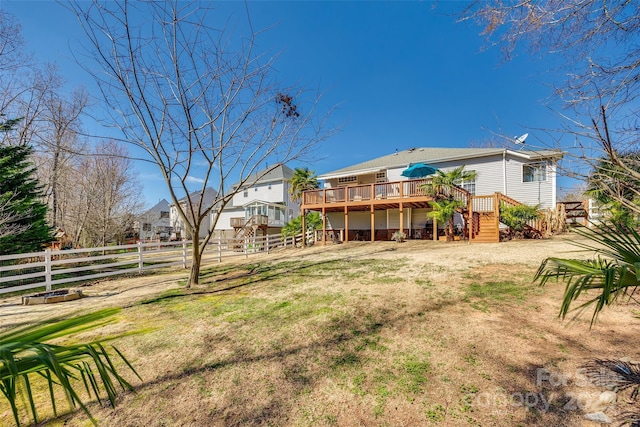 view of yard with stairs, a deck, and fence