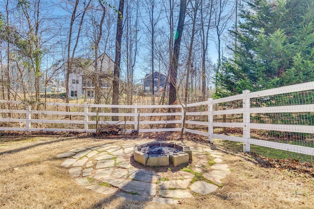 view of yard with an outdoor fire pit and fence