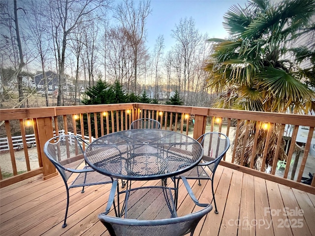 wooden deck featuring outdoor dining area