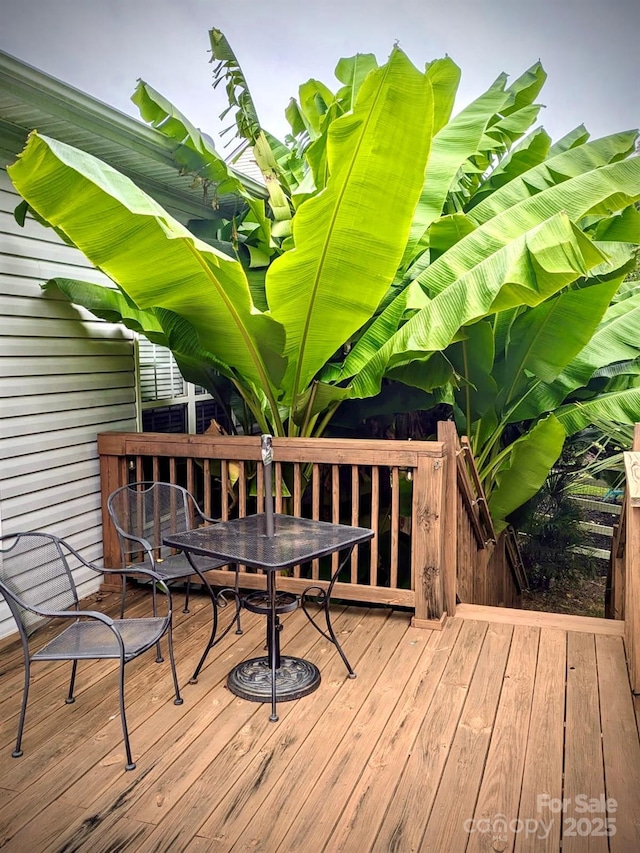 wooden deck with outdoor dining space