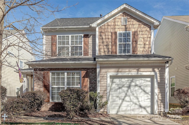 traditional-style house with concrete driveway, brick siding, and an attached garage