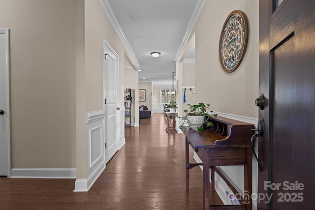 hallway with baseboards, dark wood finished floors, and crown molding