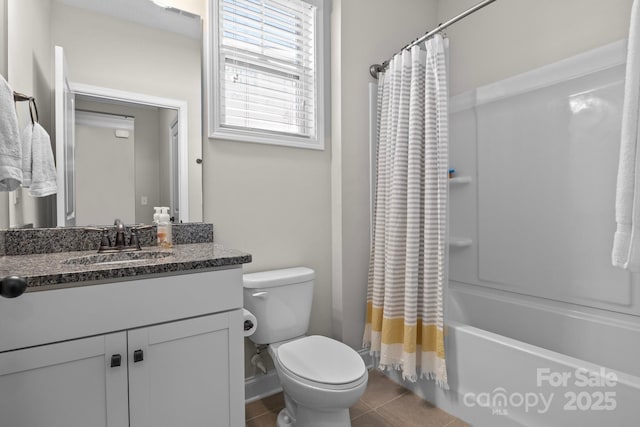 bathroom featuring tile patterned flooring, shower / tub combo with curtain, vanity, and toilet