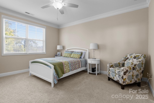 carpeted bedroom featuring visible vents, baseboards, ceiling fan, and crown molding