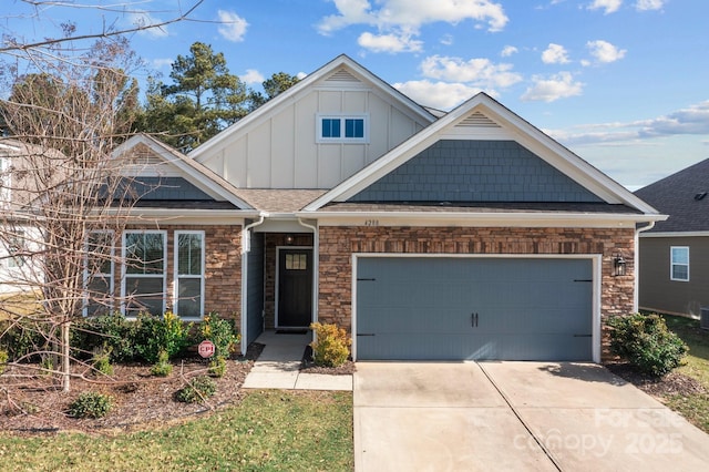 craftsman house featuring board and batten siding, concrete driveway, stone siding, and an attached garage