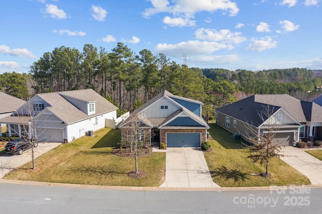 view of front of home with a garage, central AC, concrete driveway, a front lawn, and board and batten siding