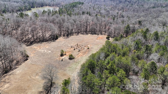 drone / aerial view featuring a wooded view