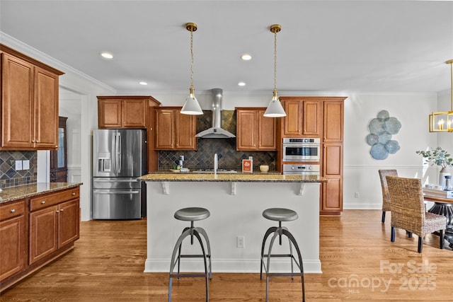 kitchen with stainless steel fridge with ice dispenser, ornamental molding, a breakfast bar, wood finished floors, and wall chimney range hood