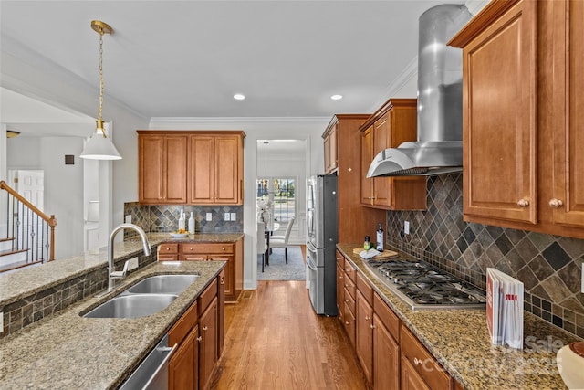 kitchen with extractor fan, stainless steel appliances, a sink, light stone countertops, and brown cabinetry