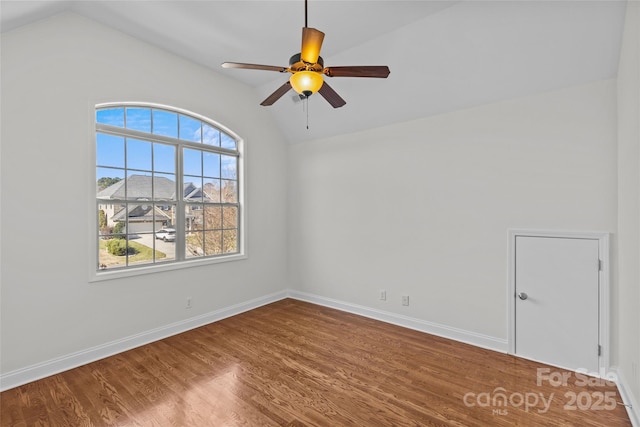 unfurnished room featuring a ceiling fan, lofted ceiling, baseboards, and wood finished floors