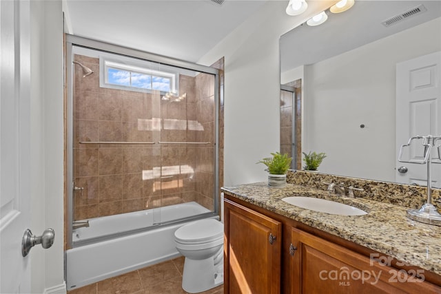 full bathroom with visible vents, toilet, enclosed tub / shower combo, tile patterned floors, and vanity