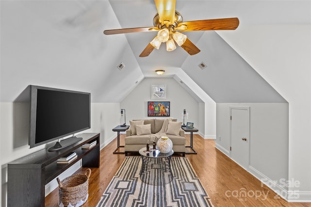 living area with lofted ceiling, visible vents, ceiling fan, and wood finished floors