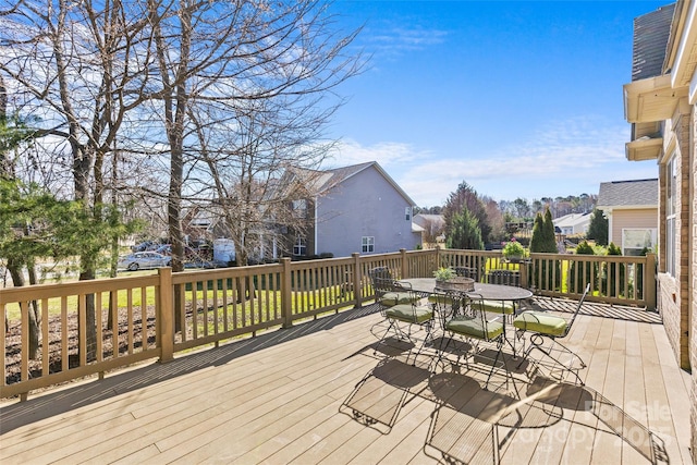 deck featuring outdoor dining space and a residential view