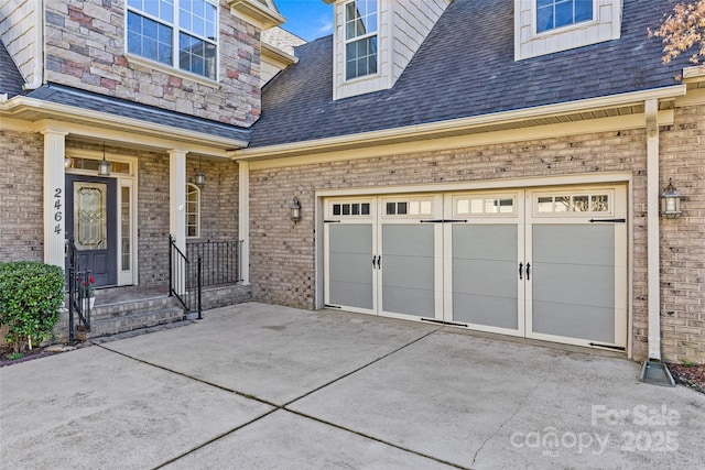 entrance to property with roof with shingles, driveway, and brick siding